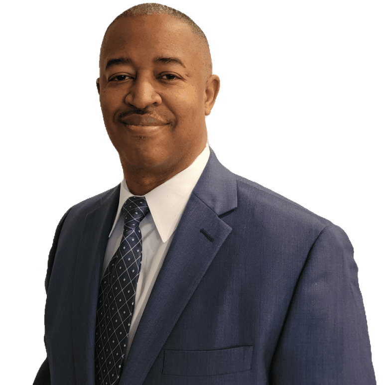 A man in a suit and tie smiling for the camera.